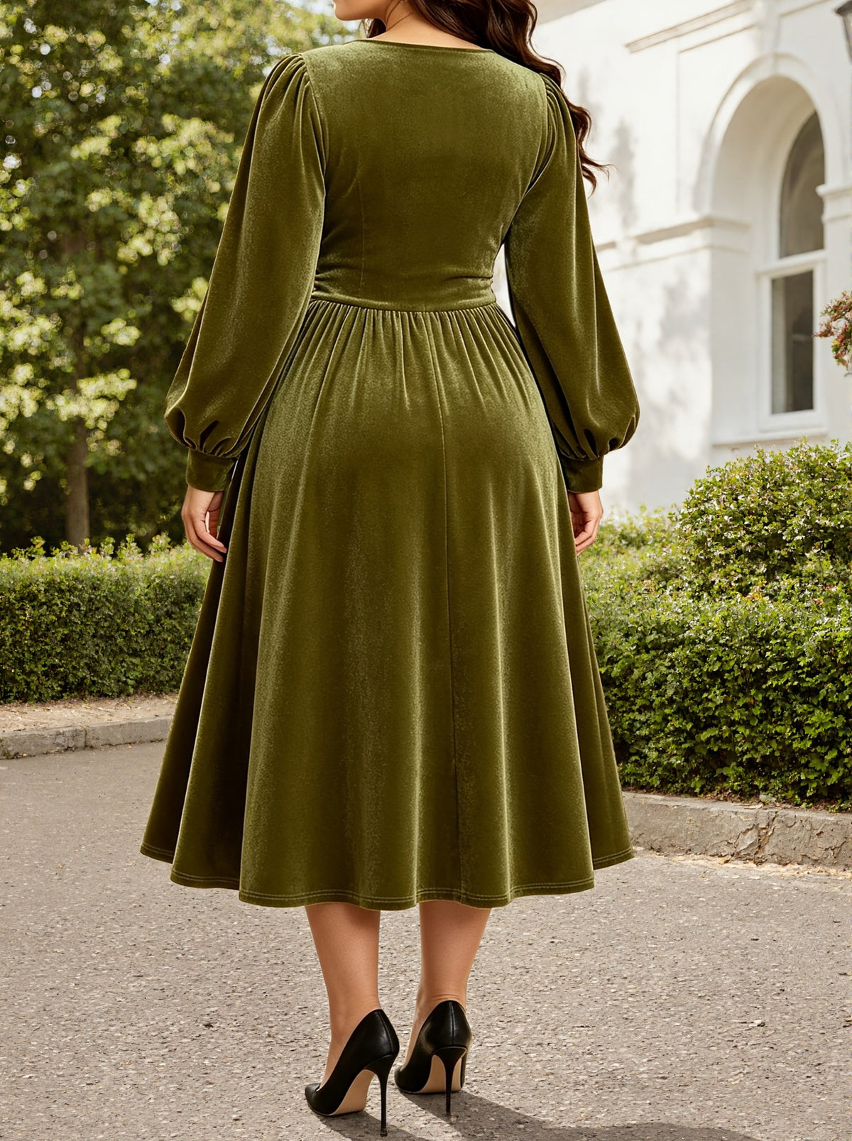Back view: green velvet midi dress with long sleeves and ruched waist, fit-and-flare