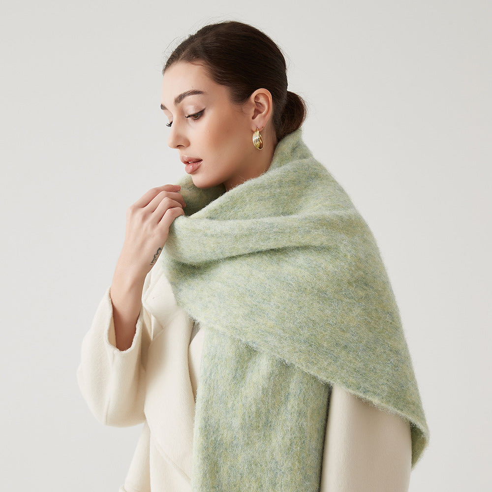 Oversized fuzzy wool-blend scarf in light sage green, wide draped wrap around neck