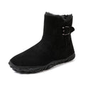 Black mid-calf snow boots with buckled side strap and thick tread sole