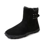 Black mid-calf snow boots with buckled side strap and thick tread sole