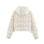 Cropped hooded puffer jacket in cream with polka dot print, rear view, elastic cuffs.