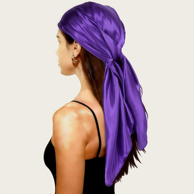 Satin head scarf in purple satin, tied back with long tail.