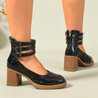 Black croc-embossed platform ankle strap pumps with block heels and triple buckle cuff