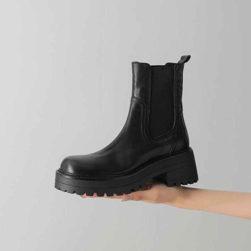 Black leather Chelsea ankle boots with elastic gore, chunky lug sole, round toe