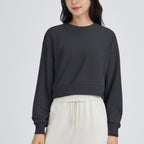 Black cropped crewneck sweatshirt with long sleeves and ribbed hem
