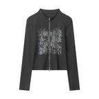 Black long-sleeve zip-up top with stand collar and distressed graphic front
