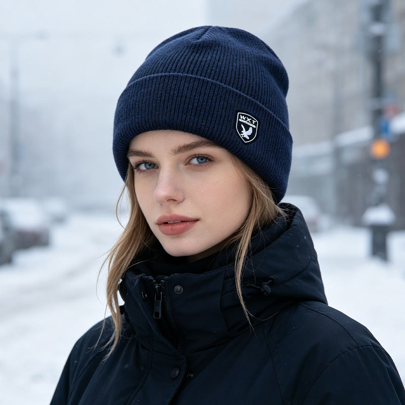 Navy blue ribbed knit beanie with fleece lining and logo patch