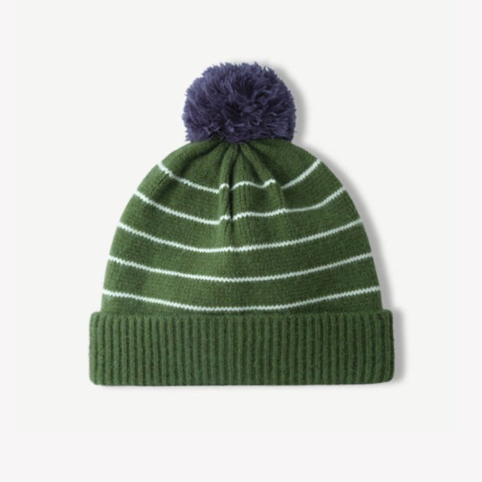 Olive green striped knit beanie with fluffy navy pom-pom and ribbed cuff