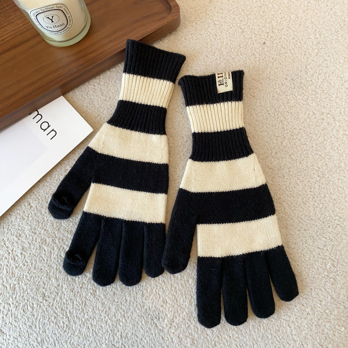 Women’s striped knit gloves in black and cream with long ribbed cuffs and five-finger design