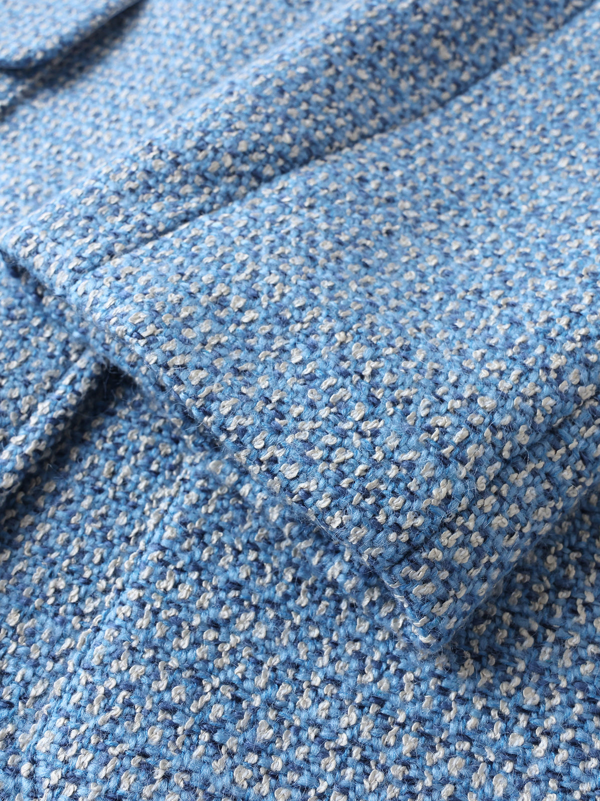 Blue tweed coat with bouclé texture and patch pocket detail