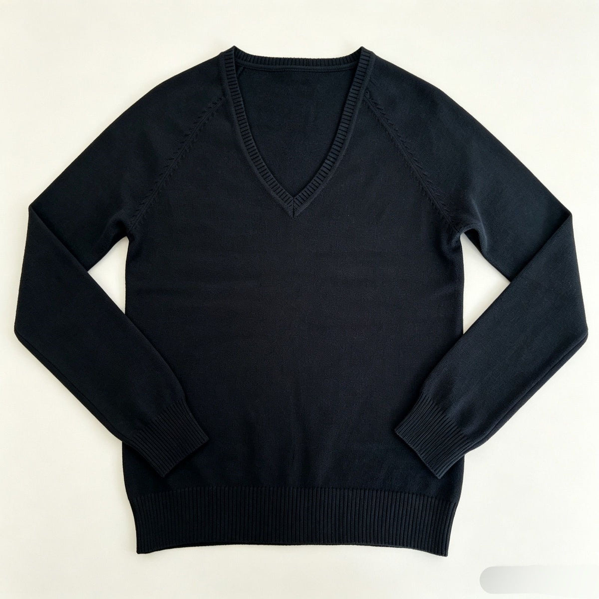 Women’s black V-neck fine-knit sweater with long sleeves and ribbed cuffs