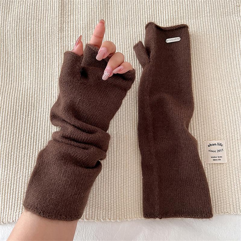 Brown fingerless knit arm warmers with thumbhole, folded cuff and label patch