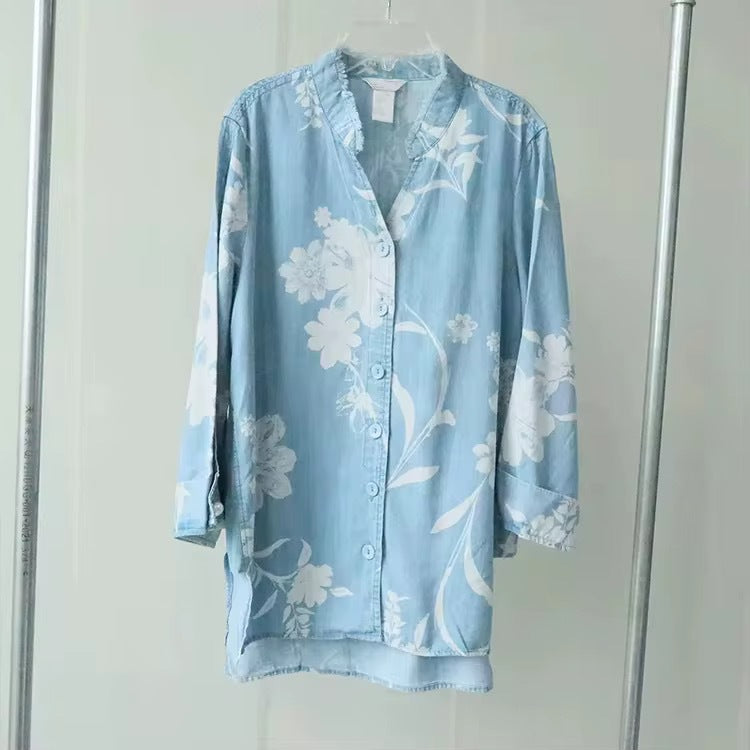 Blue sheer floral blouse with button front and long sleeves, ruffle neckline detail
