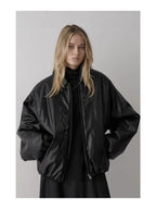 Black padded faux leather bomber jacket with wide shoulders, point collar, zip front