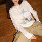 Cream long-sleeve graphic tee with blue star print and relaxed crew neckline