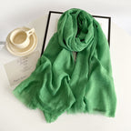 Green cotton gauze scarf with crinkle texture and frayed fringe ends, long wrap