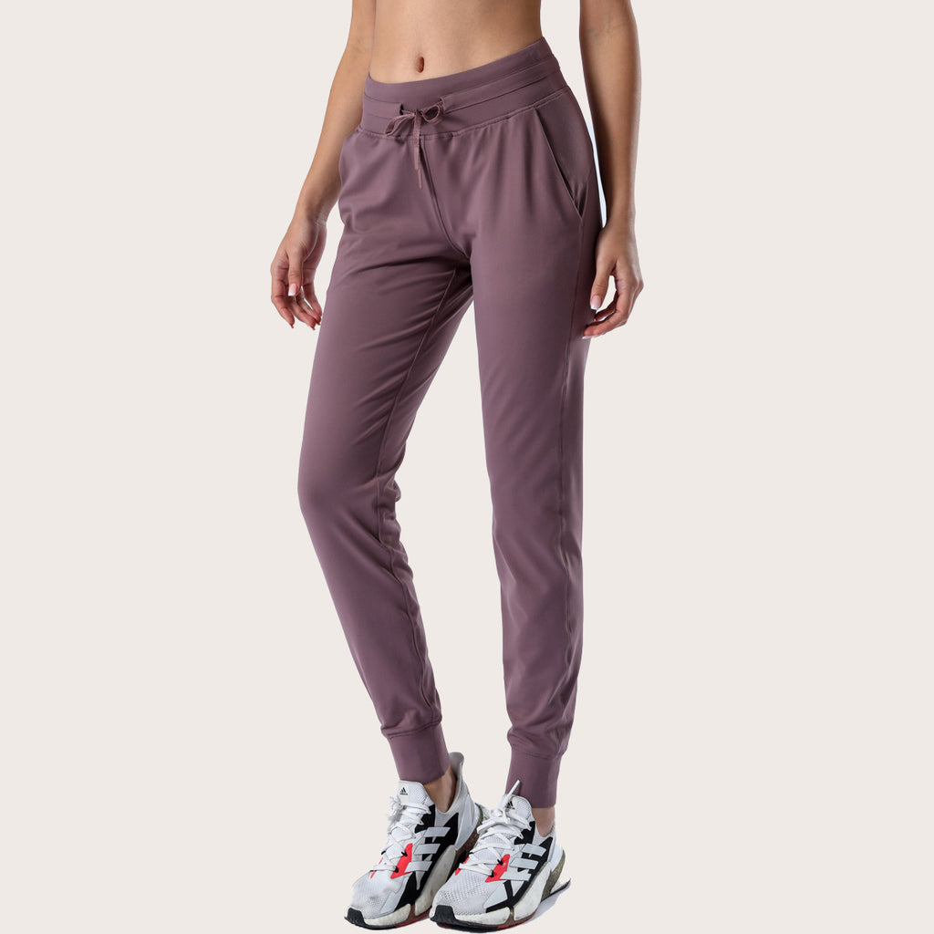 Women’s mauve slim-fit performance jogger pants with drawstring waist and ankle cuffs