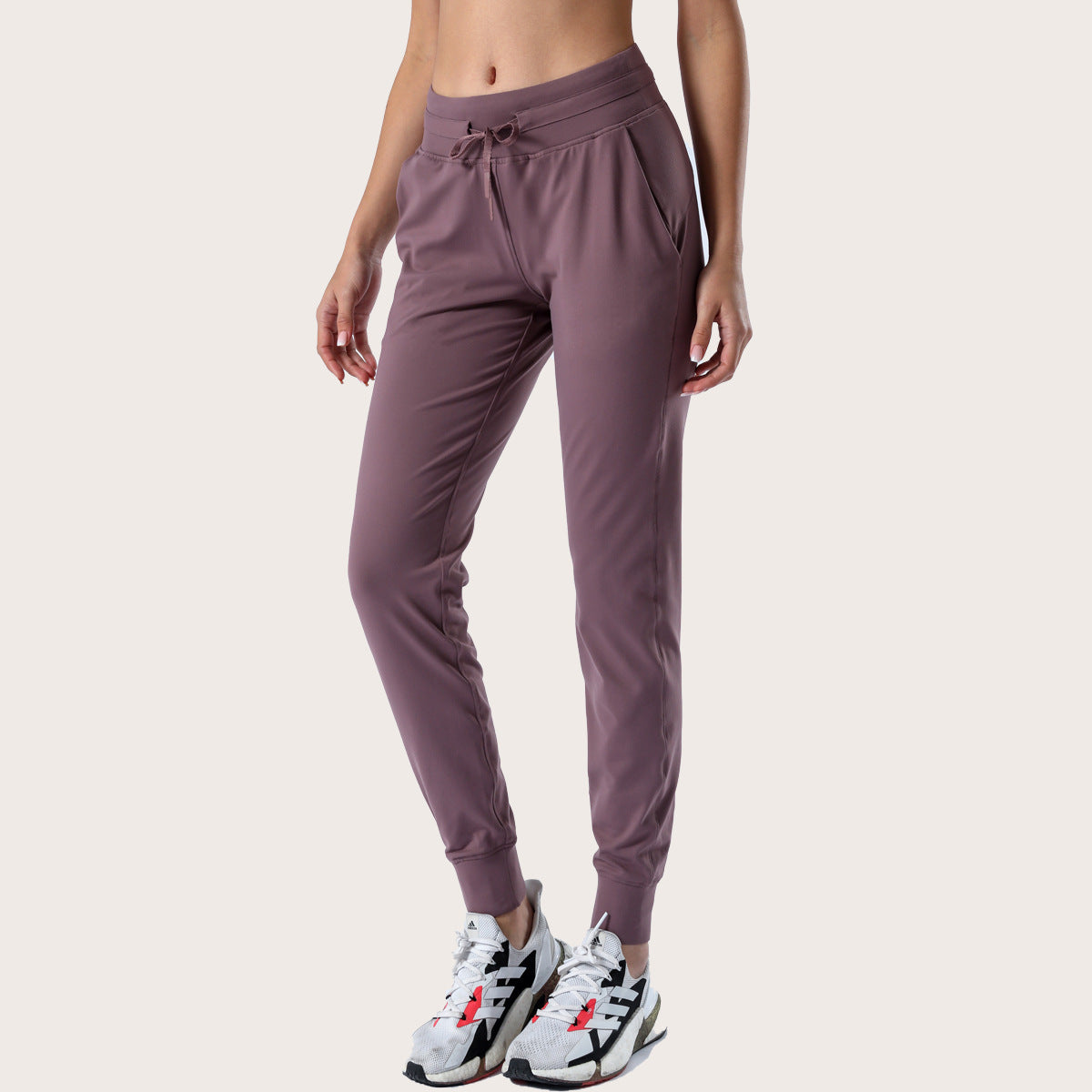 Women’s mauve slim-fit performance jogger pants with drawstring waist and ankle cuffs