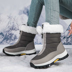 Gray mid-calf zip-up snow boots with faux fur cuffs and rugged lug sole.