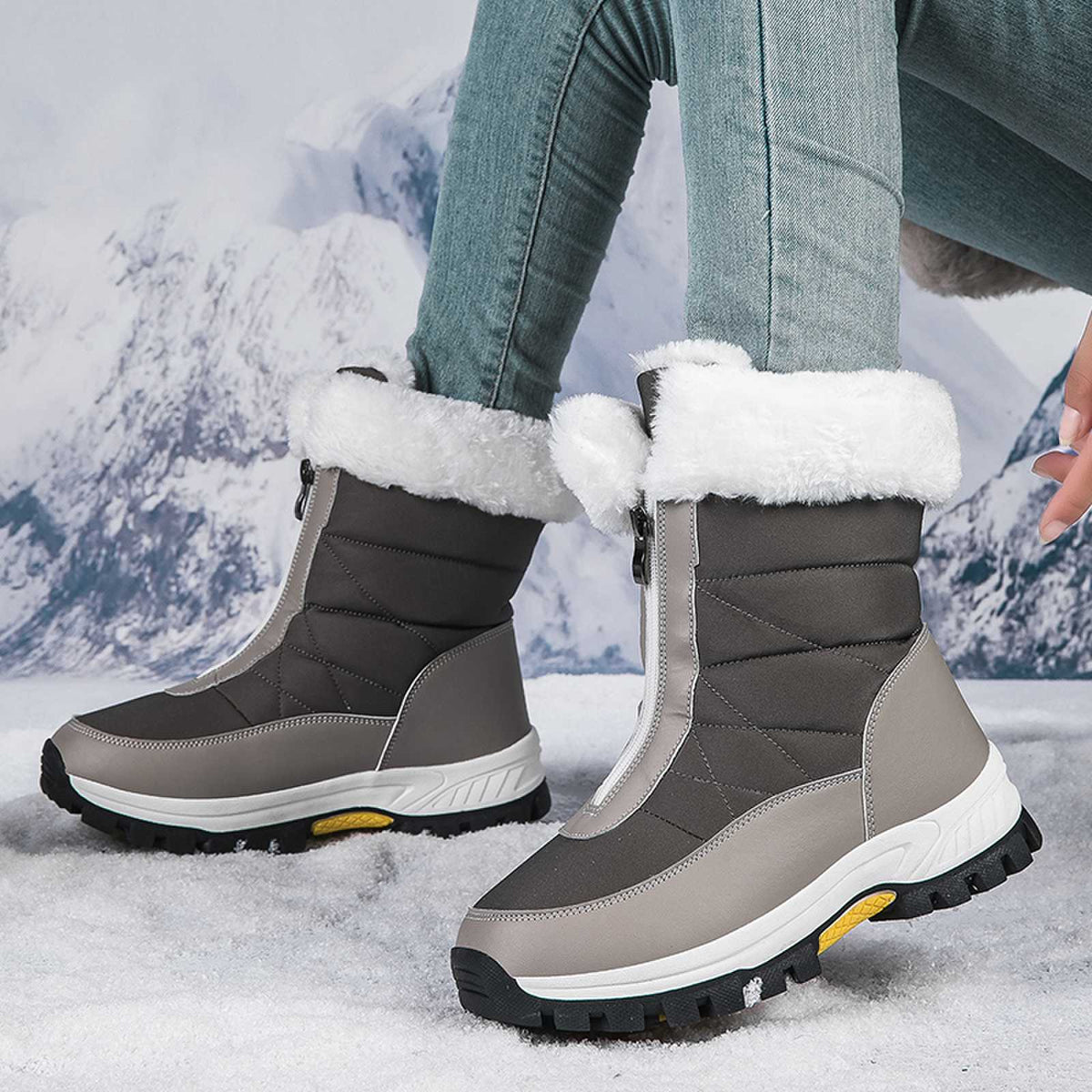 Gray mid-calf zip-up snow boots with faux fur cuffs and rugged lug sole.