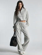 Light gray women's sweatsuit with cropped half-zip sweatshirt and wide-leg drawstring pants