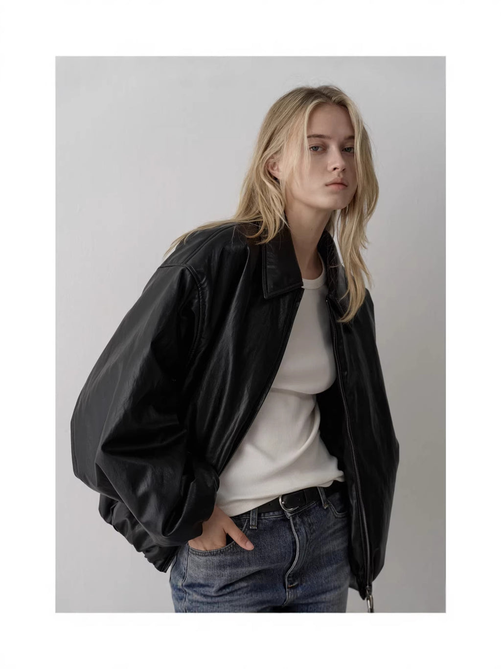Black padded bomber jacket with point collar and roomy balloon sleeves, zip front