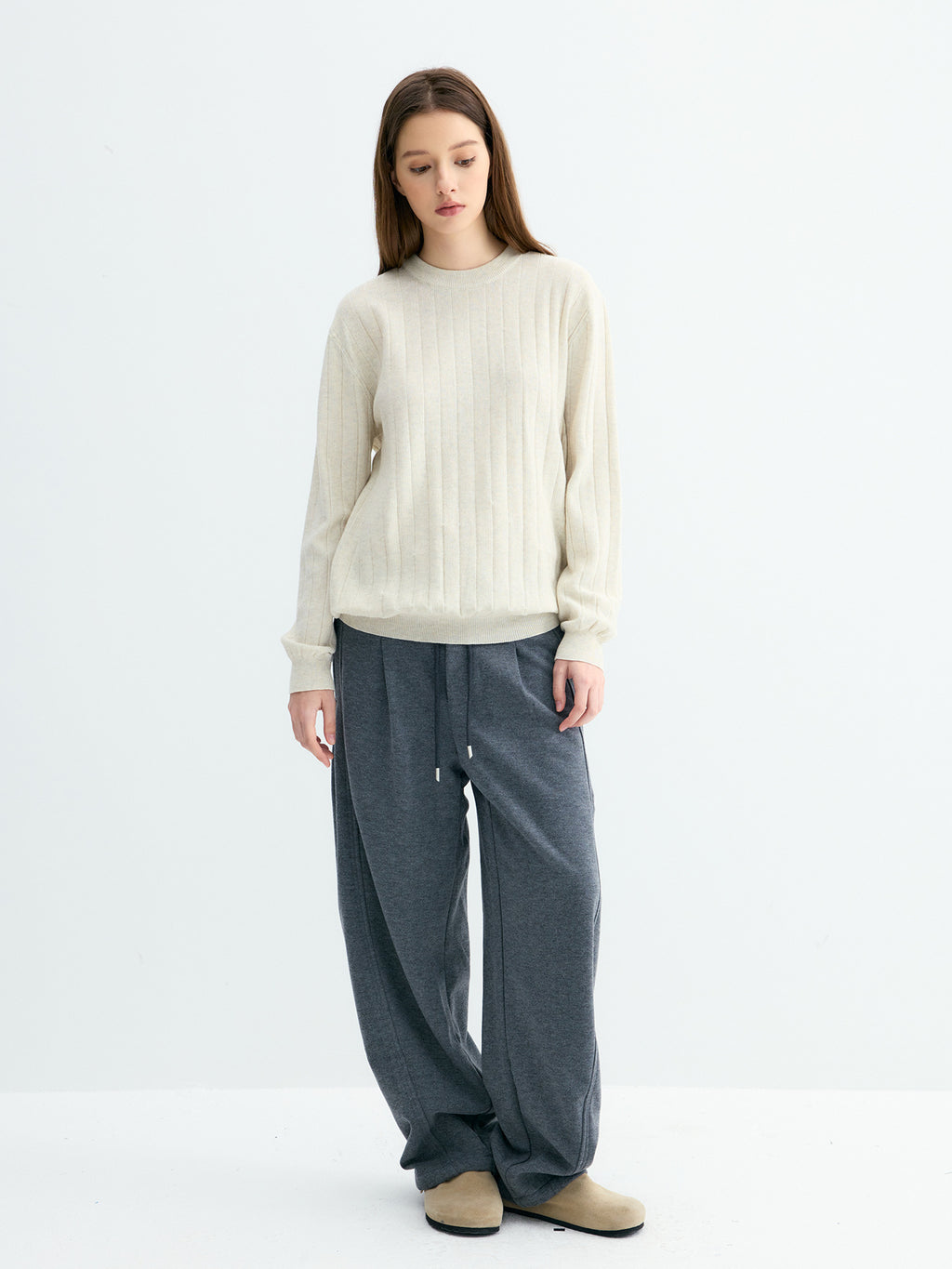 Cream ribbed crew neck sweater with wide rib knit texture and banded cuffs
