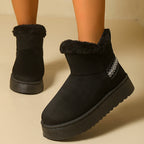 Women’s platform snow boots in black faux suede with faux fur trim, slip-on ankle style