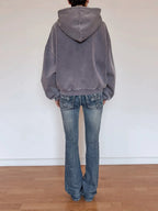Back view of cropped gray zip-up hoodie with hood