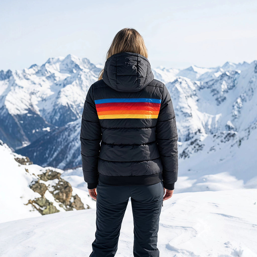 Women’s black hooded puffer jacket back view with sherpa-lined hood and rainbow stripe