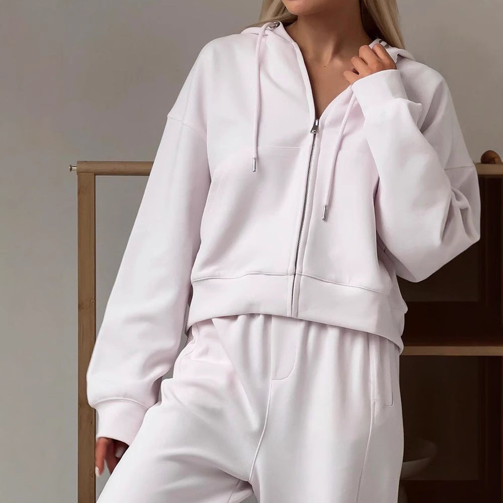 Women’s white zip-up hoodie and drawstring sweatpants set in soft cotton fleece.