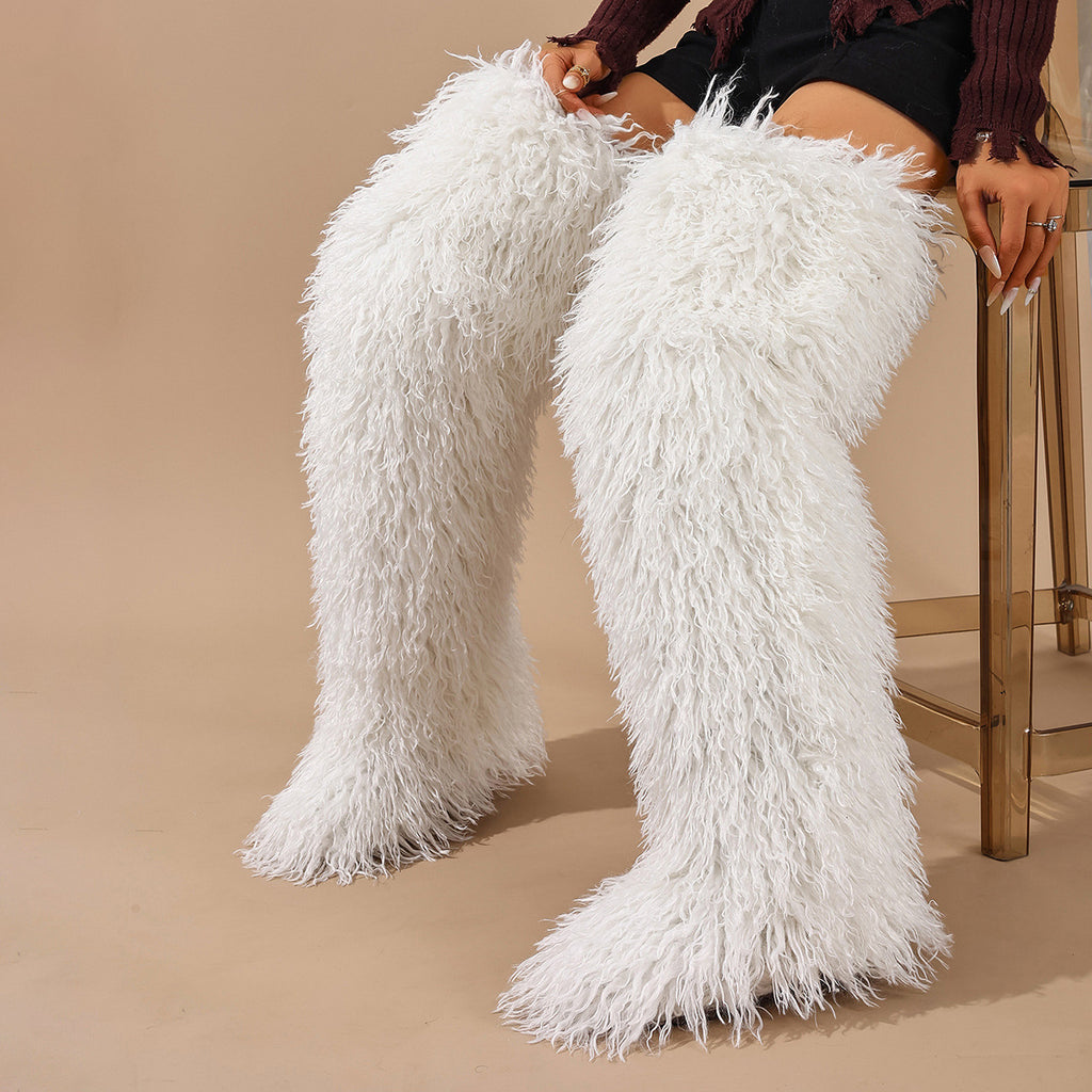 White shaggy faux fur thigh-high boots shown worn as a pair.
