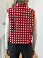 Back view of red checked sherpa fleece zip-up vest with stand collar