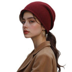 Burgundy knitted beanie hat with folded cuff, soft warm knit texture.