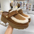 Camel-brown furry slip-on slippers with Velcro strap and thick lug sole.