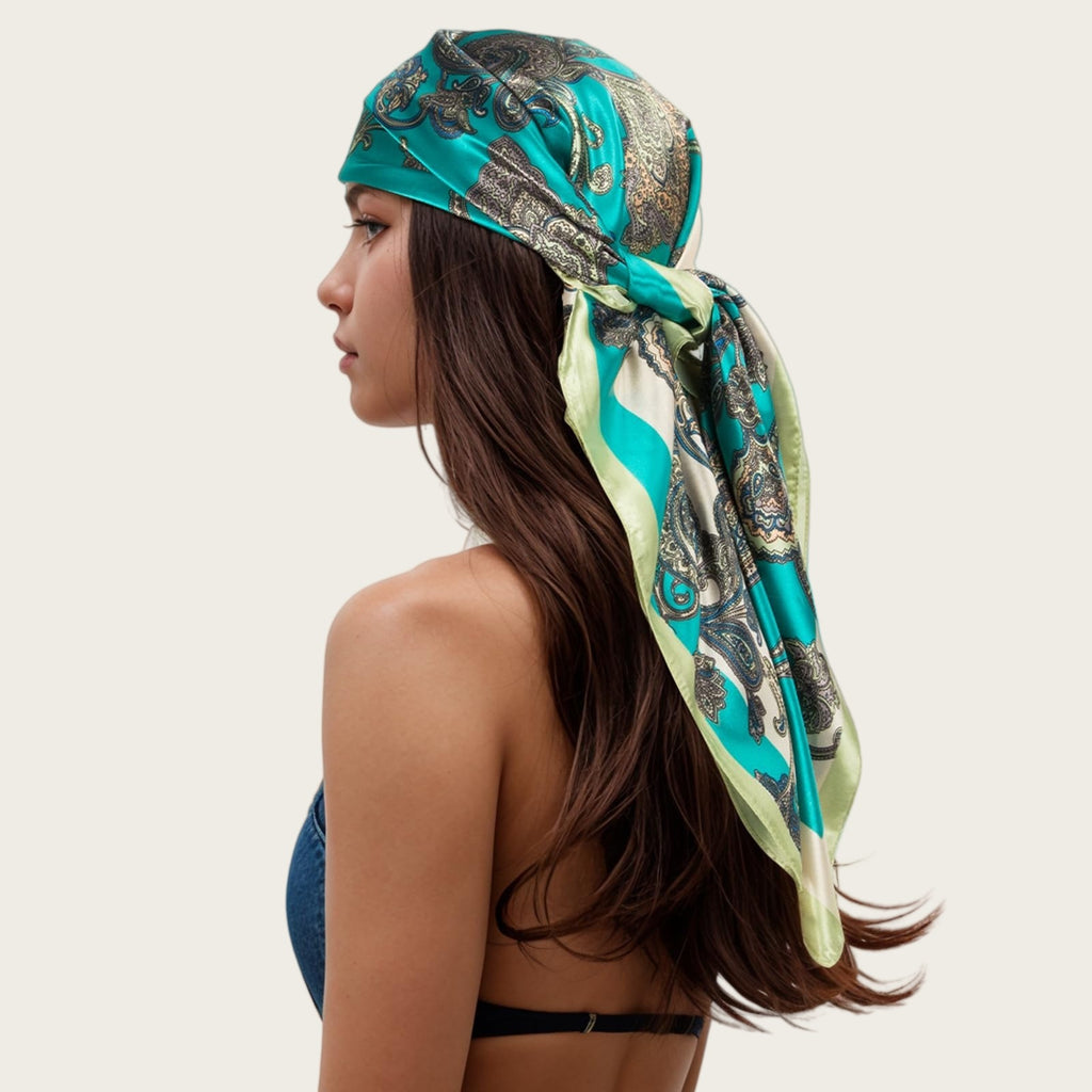 Teal satin square scarf head wrap with black-and-gold ornamental chain and paisley