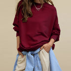 Oversized crewneck sweatshirt in burgundy with exposed seams and relaxed drop-shoulder