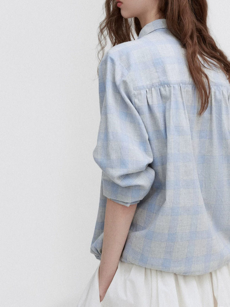 Light blue plaid blouse with tie-neck detail and puffed sleeves, back view