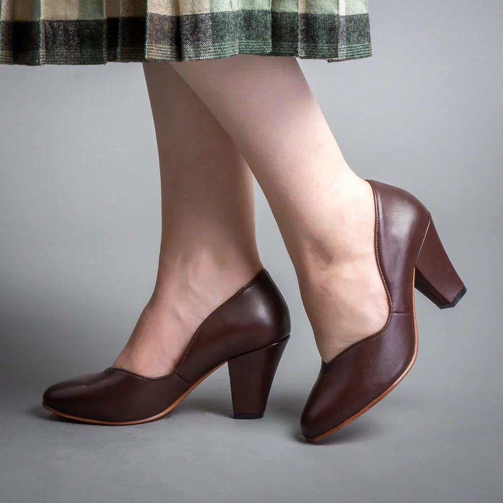 Dark brown leather pumps shown from the side, with V-cut openings and block heels