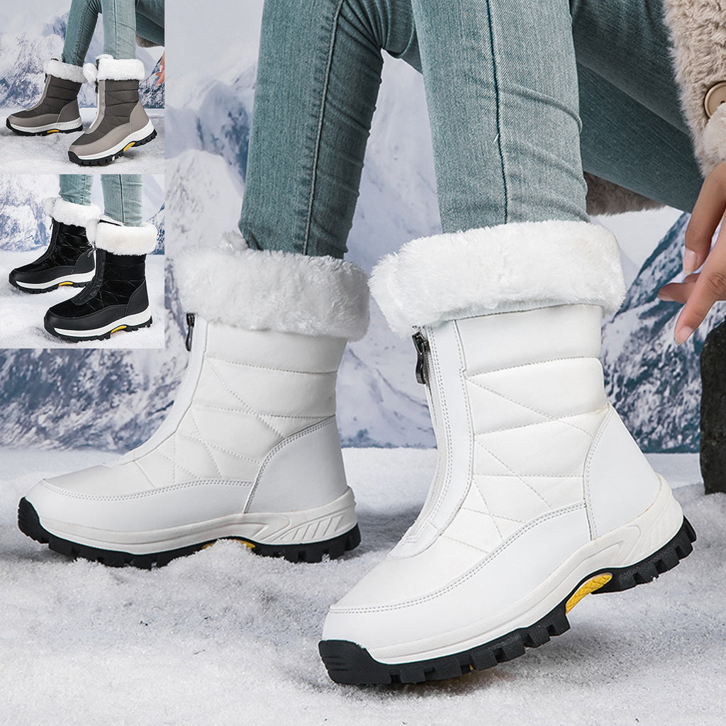 White mid-calf zip-up snow boots with faux fur lining and lug sole.