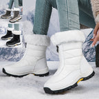 White mid-calf zip-up snow boots with faux fur lining and lug sole.