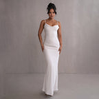 White satin maxi slip dress with thin straps and cowl neckline, smooth fitted drape.