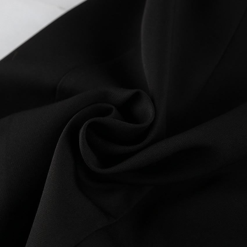 Black crepe fabric close-up with soft drape and subtle texture