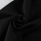 Black crepe fabric close-up with soft drape and subtle texture