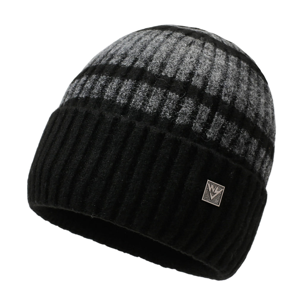 Striped knit beanie in dark gray with light stripes and metal badge on front