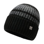 Striped knit beanie in dark gray with light stripes and metal badge on front
