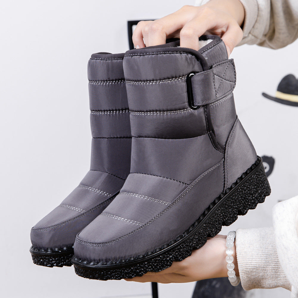 Dark gray quilted platform puffer snow boots with drawstring collar and side strap.