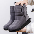 Dark gray quilted platform puffer snow boots with drawstring collar and side strap.