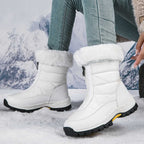 White mid-calf zip-up snow boots with faux fur lining and textured lug sole.