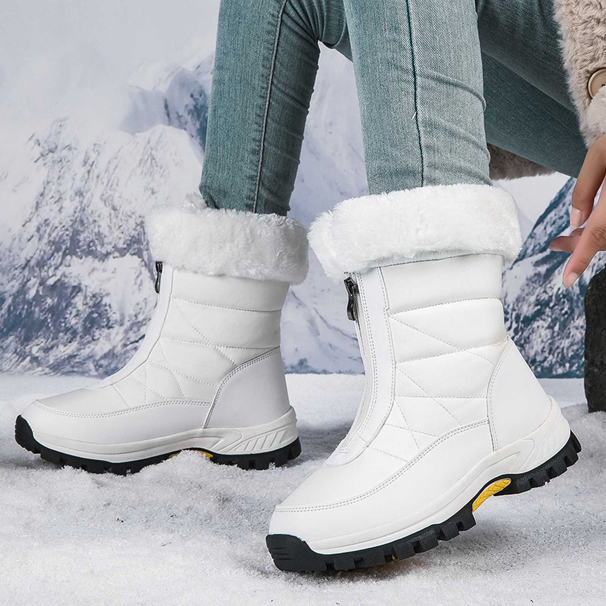 White mid-calf zip-up snow boots with faux fur lining and textured lug sole.
